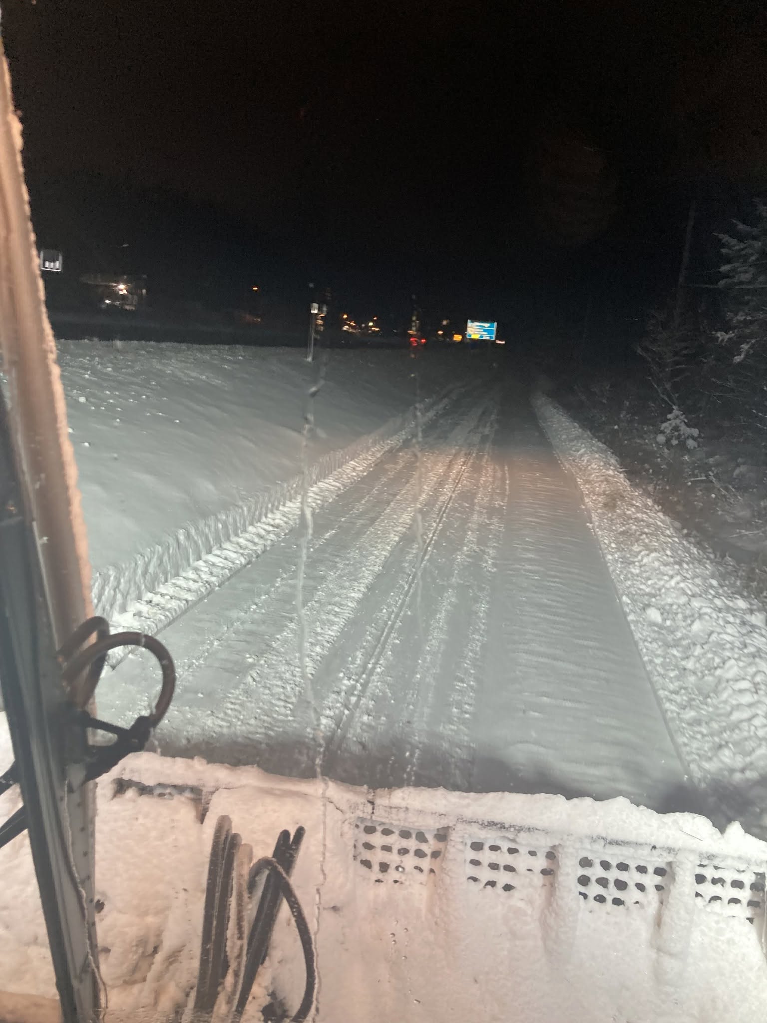 Snowmobile trail being groomed at night