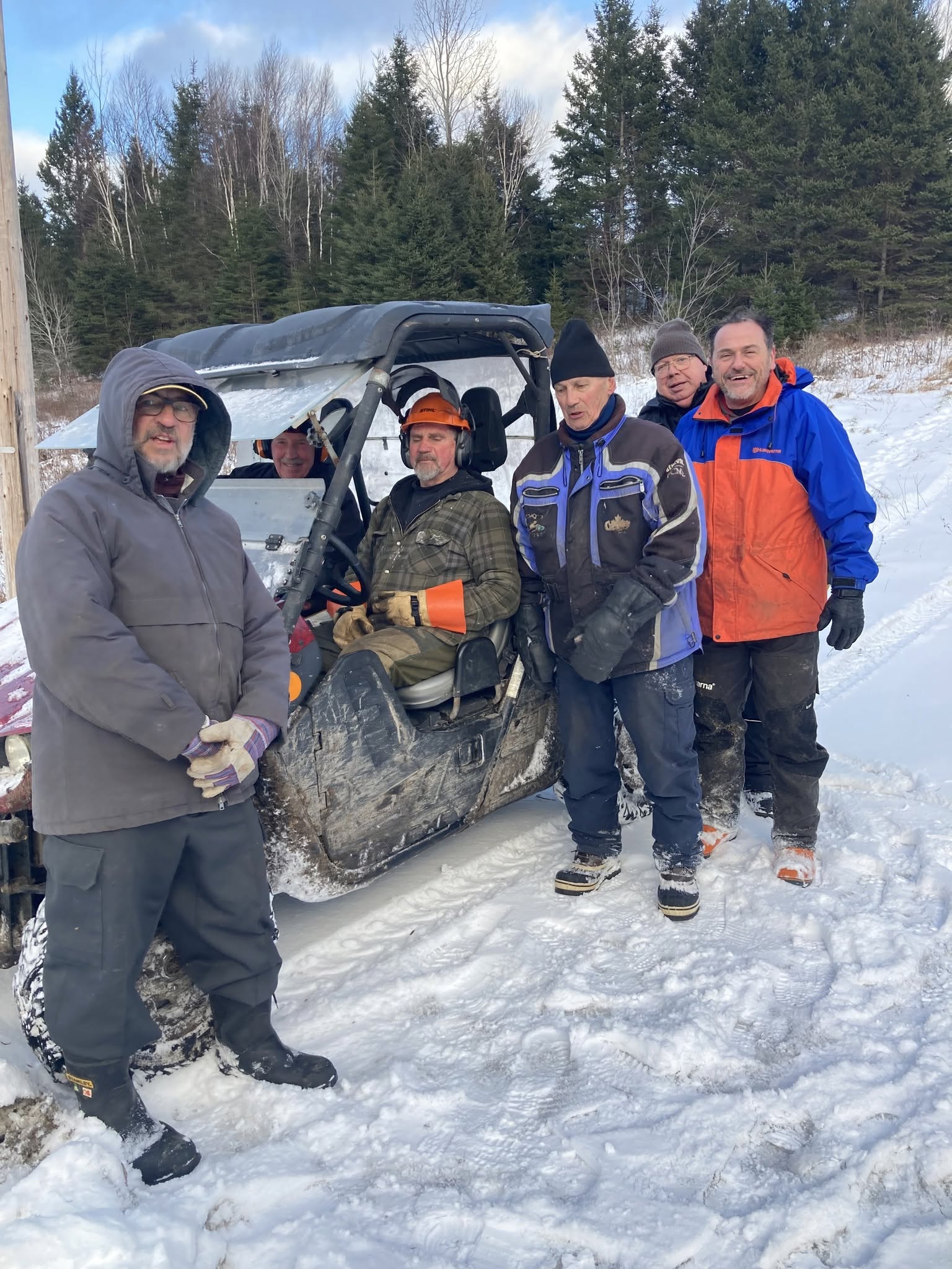 Club team gathered beside a groomer