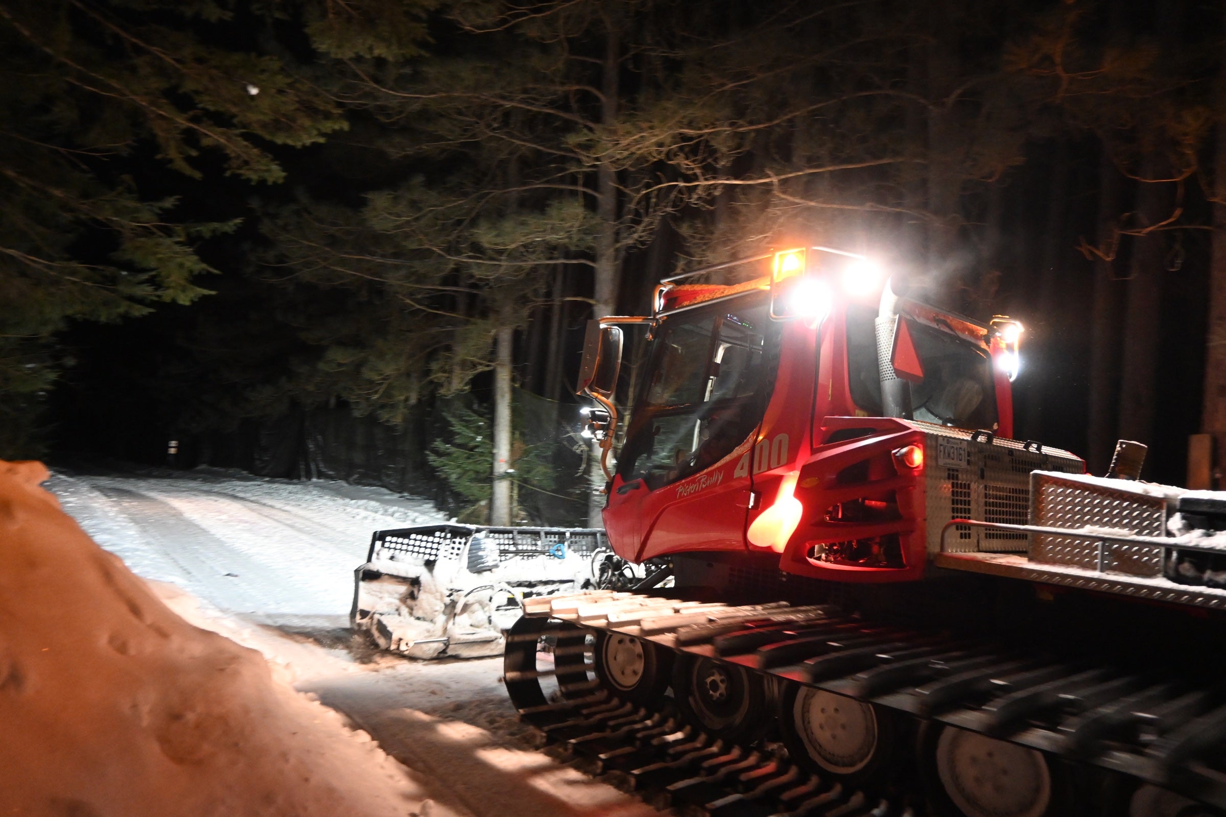 Red BR trail groomer on a forest trail